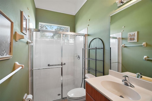 bathroom with toilet, vanity, and walk in shower