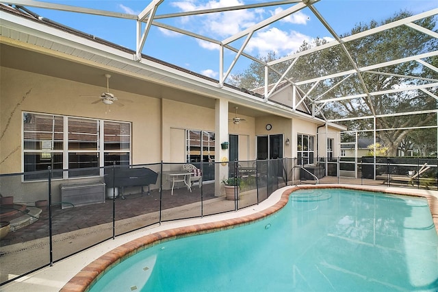 view of pool with a lanai, a patio, and ceiling fan