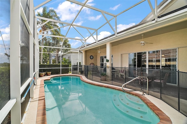 view of pool featuring a patio area, ceiling fan, and glass enclosure