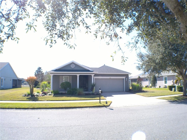 ranch-style house with a garage and a front lawn