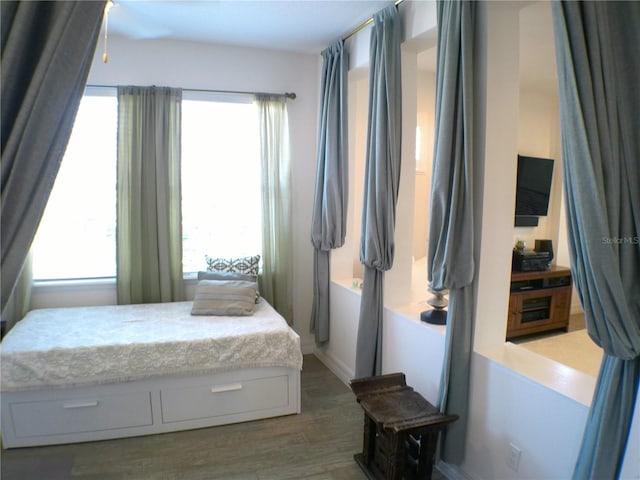 bedroom featuring dark hardwood / wood-style flooring