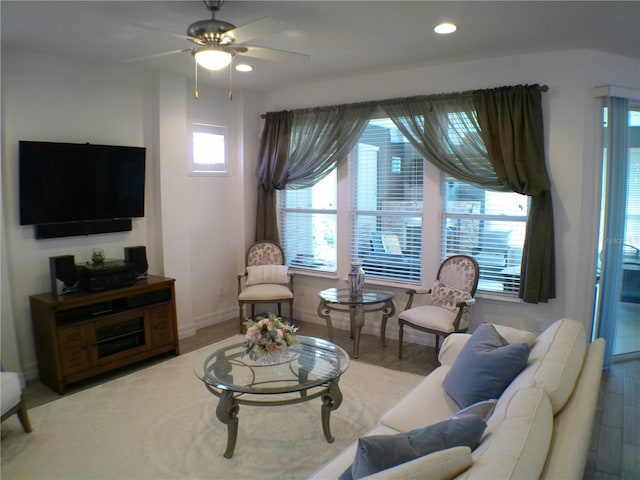 living room with hardwood / wood-style flooring and ceiling fan