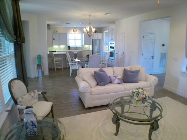 living room featuring hardwood / wood-style floors and an inviting chandelier