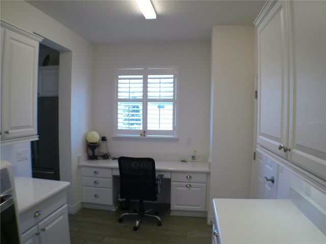 office with dark wood-type flooring