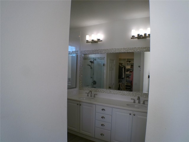 bathroom featuring vanity and tiled shower