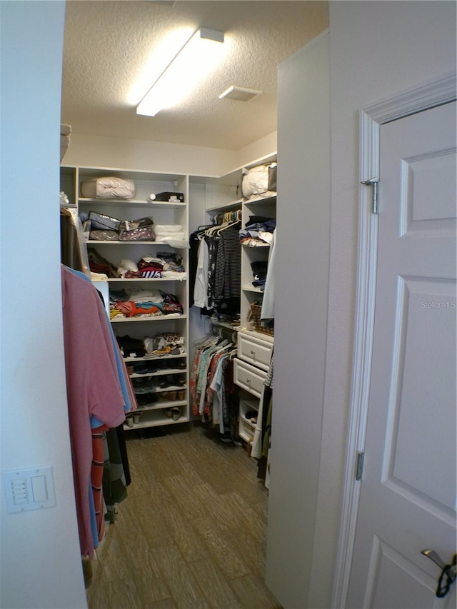 walk in closet featuring dark hardwood / wood-style flooring