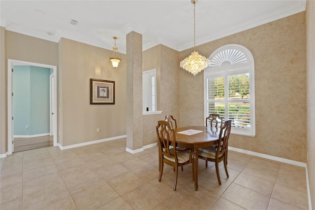 tiled dining space featuring ornamental molding and a chandelier