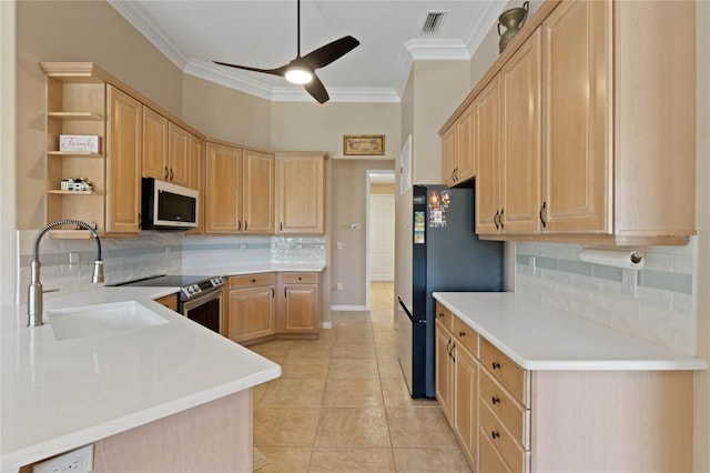 kitchen featuring light brown cabinetry, sink, light tile patterned floors, and tasteful backsplash