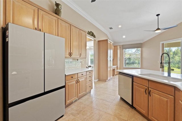 kitchen featuring lofted ceiling, sink, tasteful backsplash, refrigerator, and stainless steel dishwasher