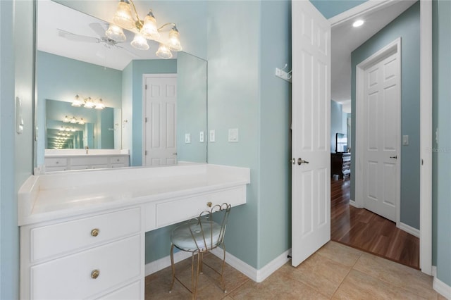 bathroom featuring tile patterned flooring, vanity, and ceiling fan