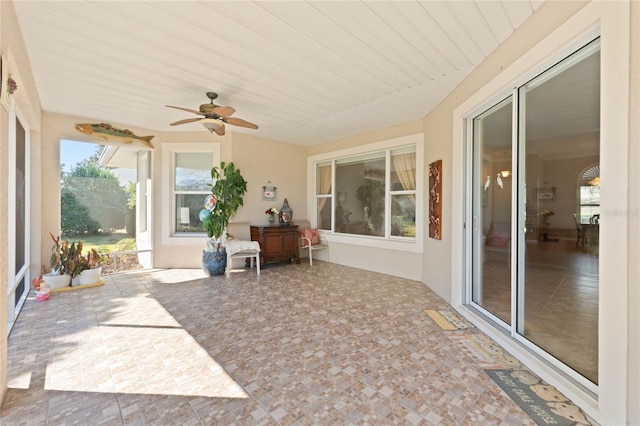 sunroom / solarium with wood ceiling and ceiling fan