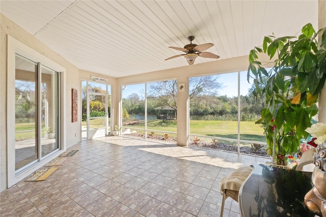 unfurnished sunroom with ceiling fan