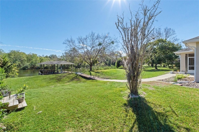 view of yard featuring a gazebo and a water view