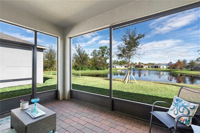 unfurnished sunroom with a water view and a healthy amount of sunlight