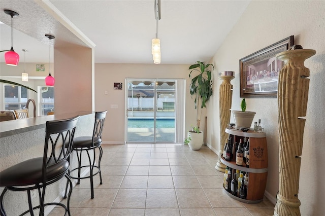 interior space with light tile patterned floors and baseboards