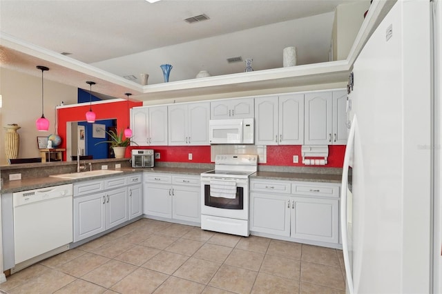 kitchen featuring white appliances, a sink, white cabinets, hanging light fixtures, and dark countertops