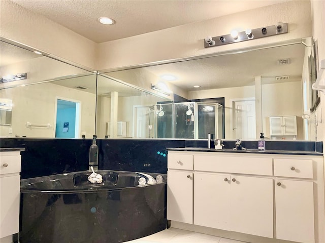 full bathroom with a garden tub, visible vents, a stall shower, vanity, and a textured ceiling