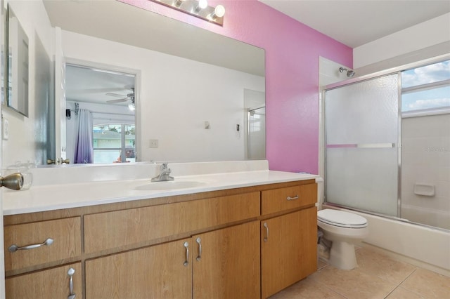 full bathroom with toilet, shower / bath combination with glass door, a ceiling fan, vanity, and tile patterned floors