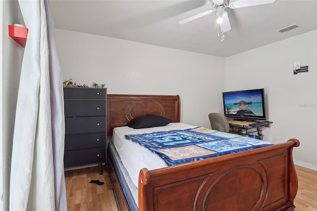 bedroom featuring ceiling fan, visible vents, and light wood-style floors