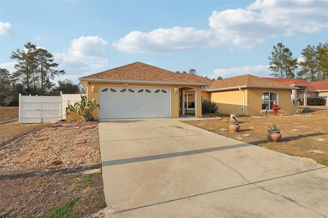 2385 SW 159th Ln, Ocala, FL 34473 - single story home featuring stucco siding, driveway, and an attached garage