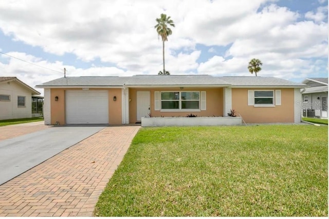 ranch-style home with a garage and a front lawn