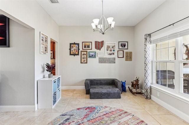 living area featuring light tile patterned floors and a chandelier