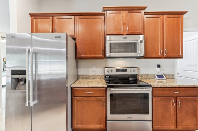 kitchen featuring light stone counters and stainless steel appliances