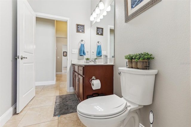 bathroom with tile patterned flooring, vanity, and toilet