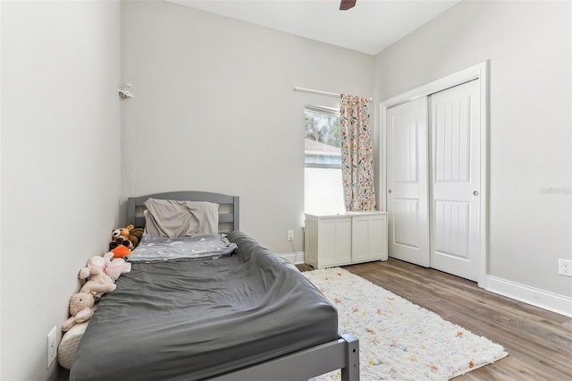 bedroom featuring wood-type flooring, a closet, and ceiling fan