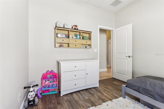 bedroom with dark hardwood / wood-style floors