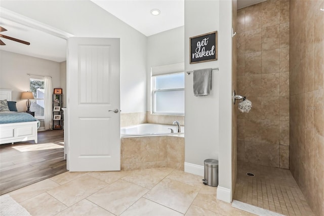 bathroom with tile patterned flooring, shower with separate bathtub, vaulted ceiling, and ceiling fan