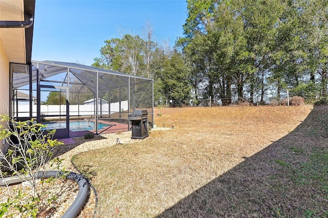 view of yard featuring a fenced in pool and a lanai