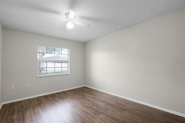 spare room featuring dark hardwood / wood-style floors and ceiling fan