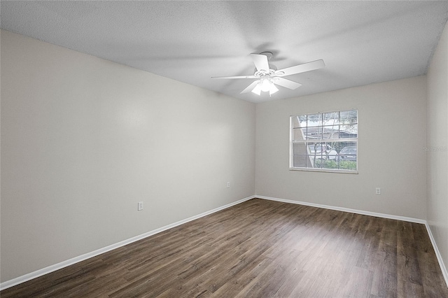 spare room featuring ceiling fan, dark hardwood / wood-style floors, and a textured ceiling