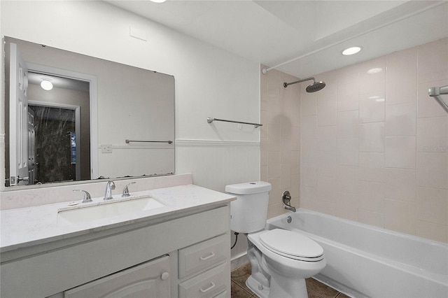 full bathroom with tiled shower / bath, vanity, toilet, and tile patterned flooring