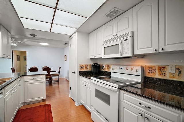 kitchen featuring visible vents, light wood-style flooring, white appliances, and white cabinets