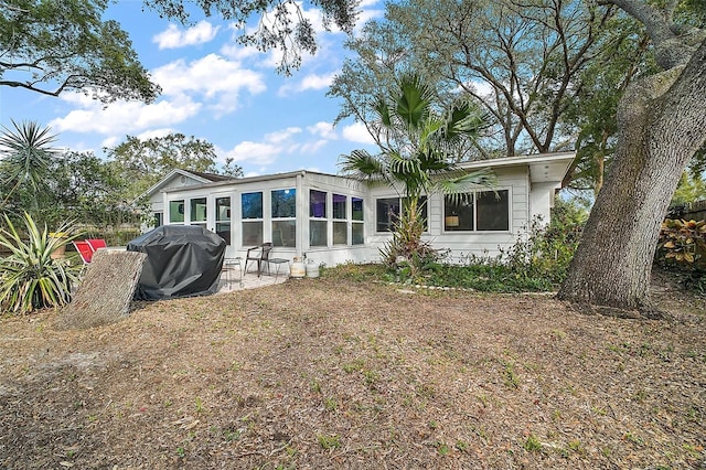 back of house featuring a sunroom and a patio