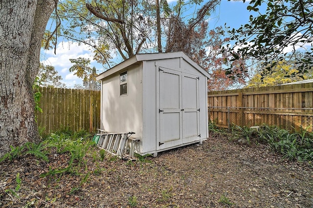 view of shed with a fenced backyard