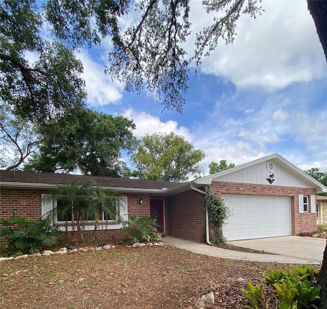ranch-style house with brick siding, an attached garage, and driveway