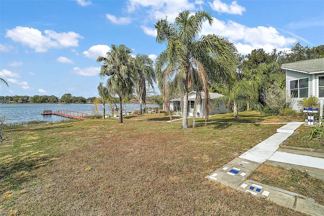 view of yard featuring a water view and a boat dock