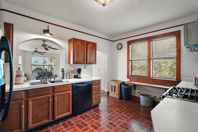 kitchen featuring ceiling fan, black dishwasher, sink, and a textured ceiling