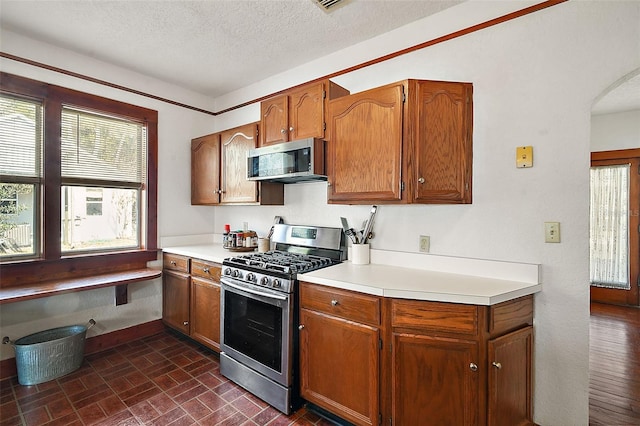 kitchen featuring stainless steel appliances and a textured ceiling