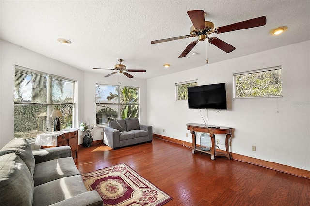 living room with plenty of natural light, a textured ceiling, and dark hardwood / wood-style flooring