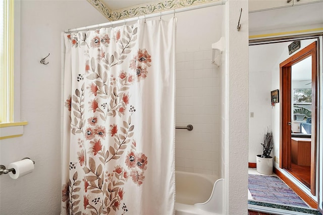 bathroom with shower / bathtub combination with curtain