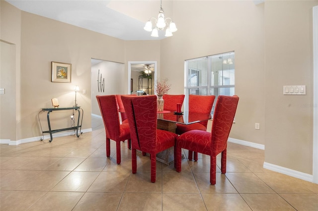 tiled dining area with ceiling fan with notable chandelier