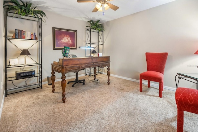 carpeted home office featuring ceiling fan