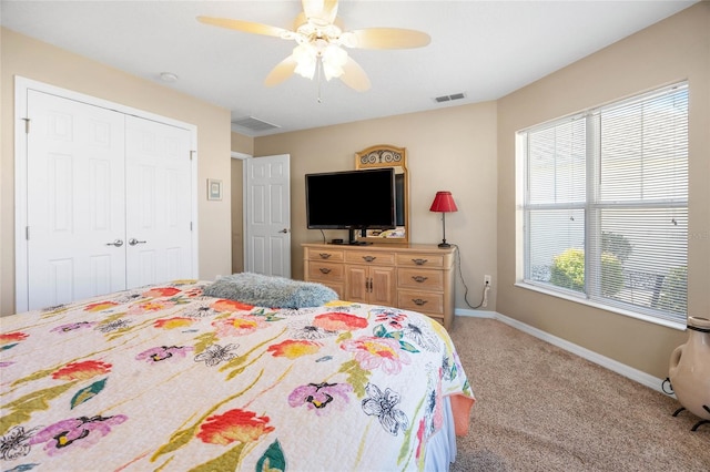 bedroom with a closet, ceiling fan, and carpet flooring