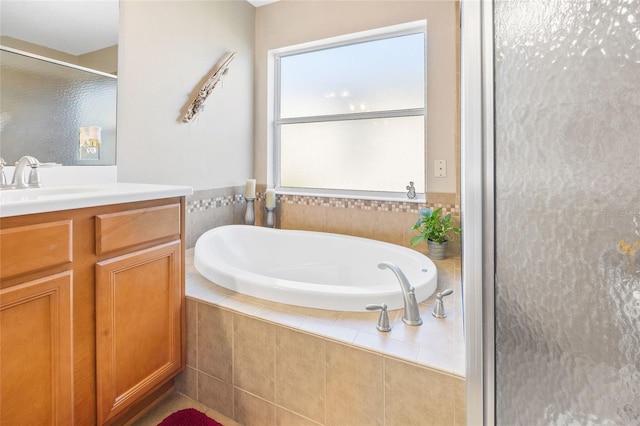 bathroom featuring plus walk in shower and vanity