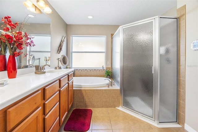 bathroom featuring tile patterned floors, separate shower and tub, and vanity