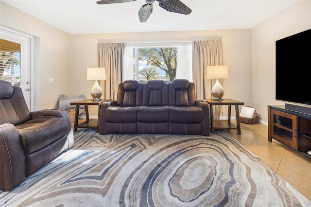 living room featuring plenty of natural light, light tile patterned floors, and ceiling fan